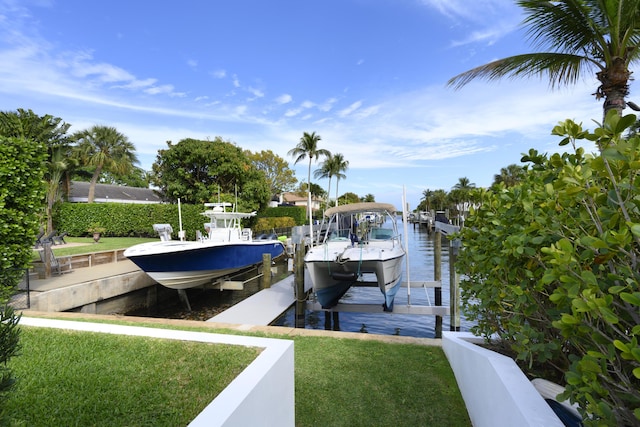 dock area with a lawn, a water view, and boat lift