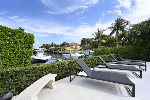 view of patio / terrace with a boat dock and a water view