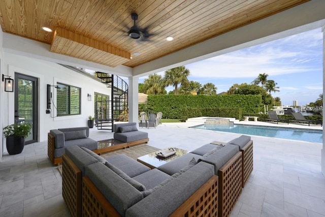 view of patio with stairs, a pool with connected hot tub, an outdoor living space, and a ceiling fan