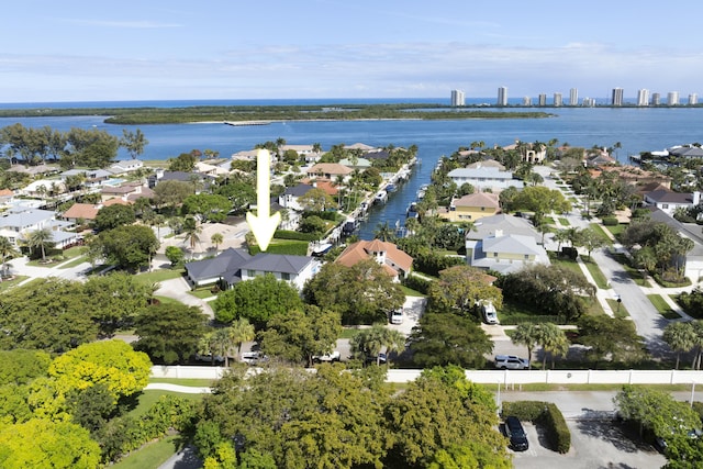 drone / aerial view featuring a residential view and a water view