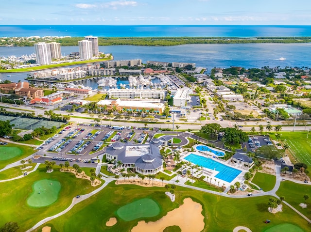 birds eye view of property with a water view and golf course view