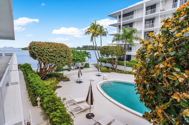 community pool featuring a patio area and a water view