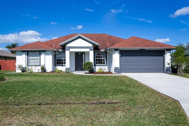 ranch-style house featuring a garage and a front yard