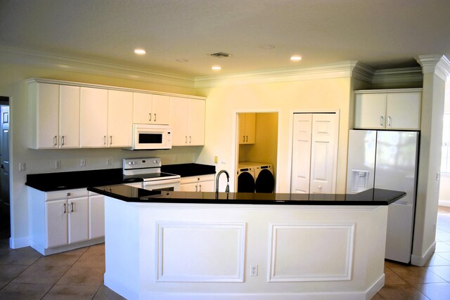 2749 SW Backton Ave, Port Saint Lucie, FL 34987 - kitchen featuring white appliances, independent washer and dryer, dark countertops, light tile patterned floors, and white cabinets