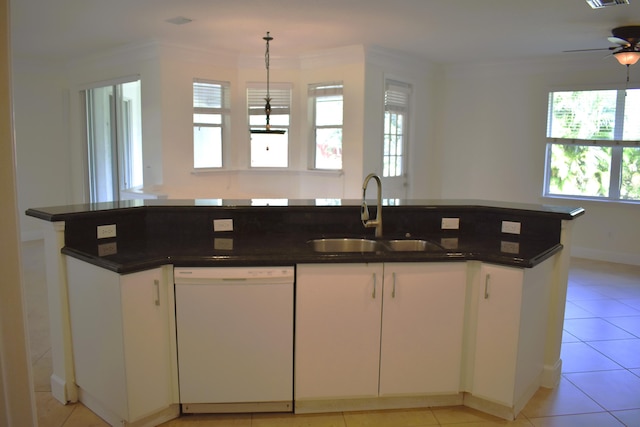 2749 SW Backton Ave, Port Saint Lucie, FL 34987 - kitchen featuring dishwasher, a sink, healthy amount of natural light, dark countertops, and crown molding