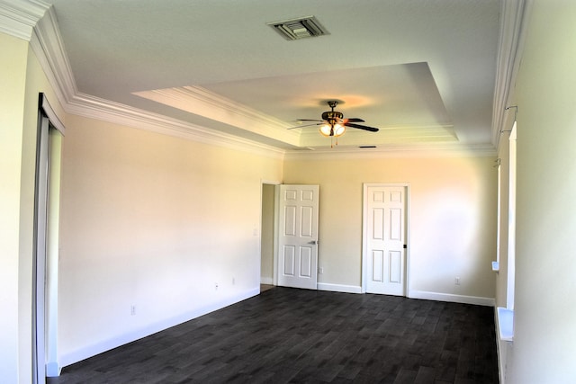 2749 SW Backton Ave, Port Saint Lucie, FL 34987 - unfurnished bedroom featuring a tray ceiling, crown molding, dark wood finished floors, and baseboards