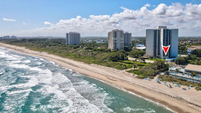 birds eye view of property with a water view and a view of the beach