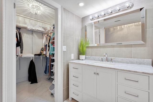 4545 N Ocean Blvd Unit 3A, Boca Raton, FL 33431 - bathroom featuring marble finish flooring, vanity, and a walk in closet