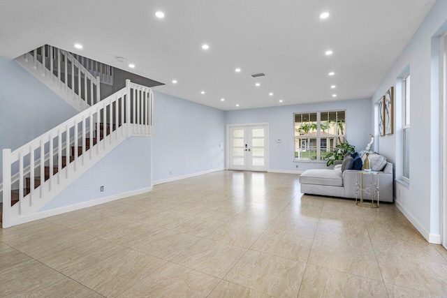 unfurnished living room featuring recessed lighting, visible vents, baseboards, french doors, and stairway