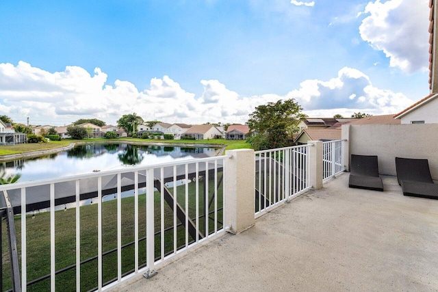 balcony with a water view and a residential view