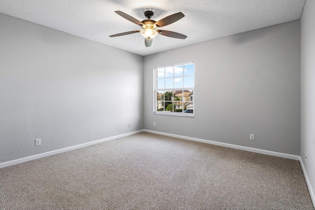 spare room featuring a ceiling fan, carpet flooring, a textured ceiling, and baseboards