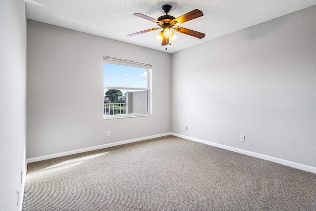 unfurnished room featuring a textured ceiling, carpet floors, a ceiling fan, and baseboards