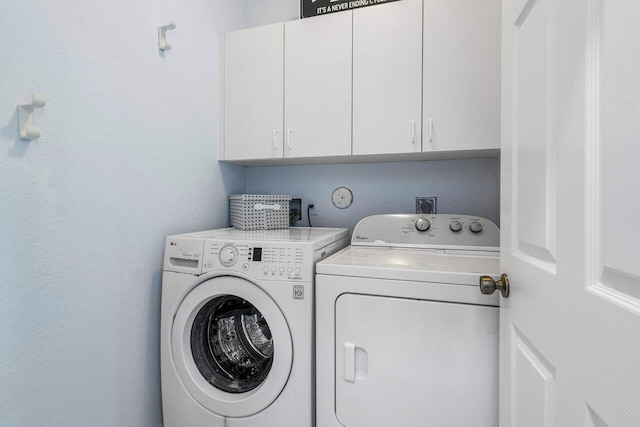 laundry room featuring cabinet space and washing machine and dryer