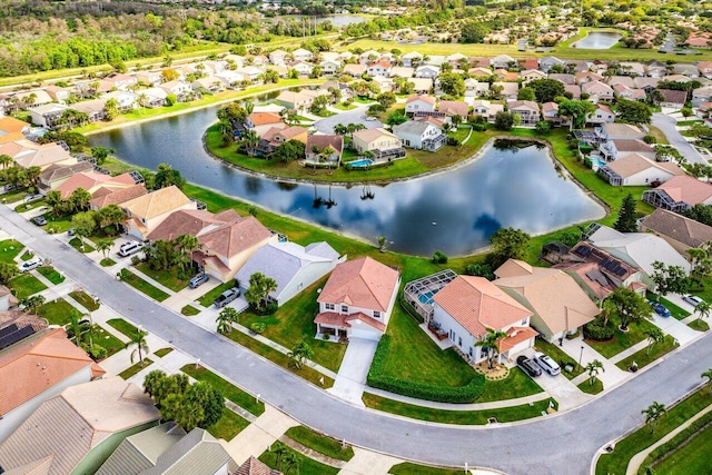 bird's eye view featuring a water view and a residential view