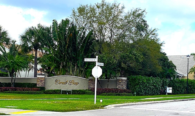 community sign featuring a lawn