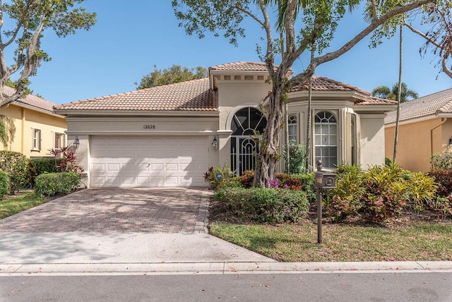 mediterranean / spanish house with a garage