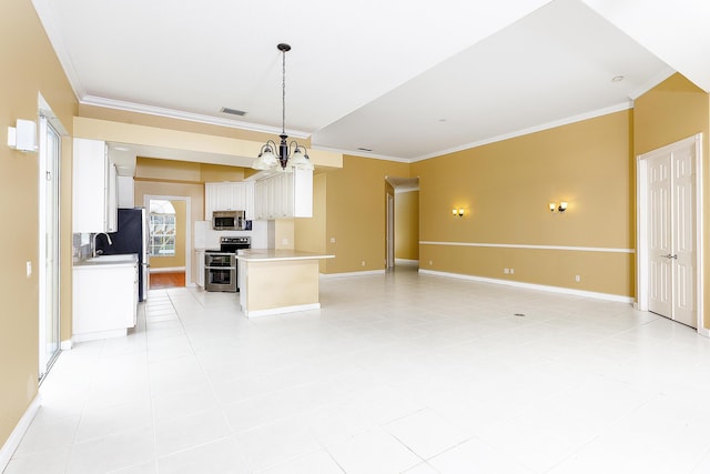 kitchen with a center island, ornamental molding, pendant lighting, stainless steel appliances, and white cabinets