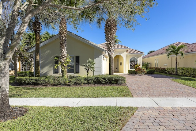 mediterranean / spanish-style house with a front lawn