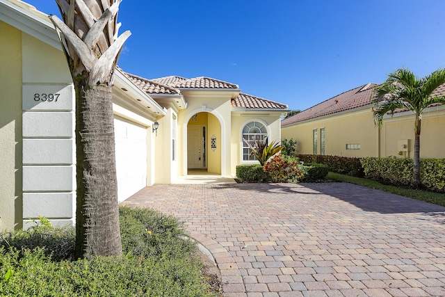 view of exterior entry featuring a garage