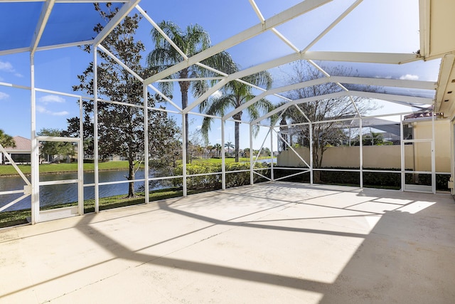 view of patio featuring a lanai and a water view