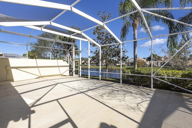 view of patio with a water view and a lanai