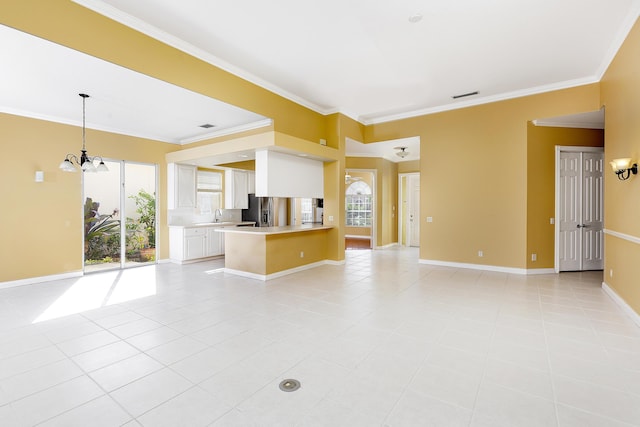 unfurnished living room featuring crown molding, a wealth of natural light, a chandelier, and light tile patterned floors