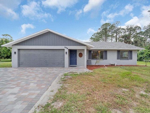 ranch-style home featuring a garage and a front yard