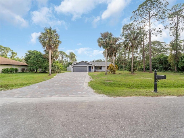 ranch-style home with a garage and a front yard