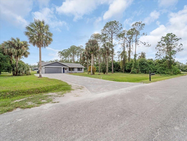 view of front of home with a garage and a front yard