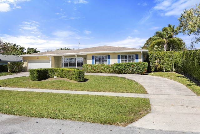 single story home featuring a garage and a front lawn