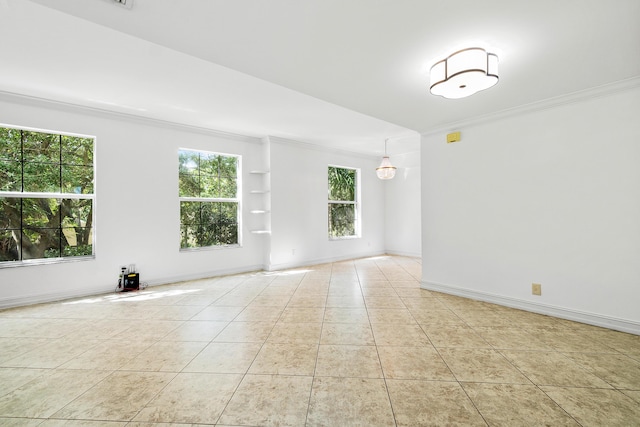 unfurnished room featuring crown molding and light tile patterned floors