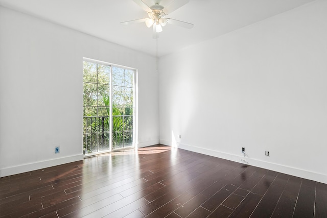 spare room featuring dark wood-type flooring and ceiling fan