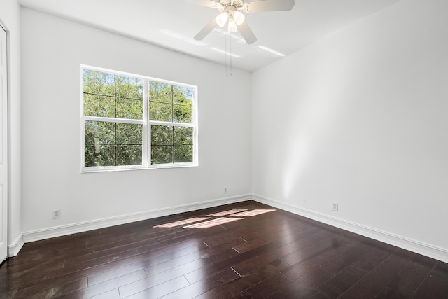 empty room with dark wood-type flooring and ceiling fan