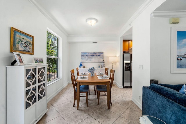 dining space with ornamental molding and light tile patterned floors