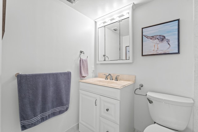 half bathroom with visible vents, vanity, and toilet