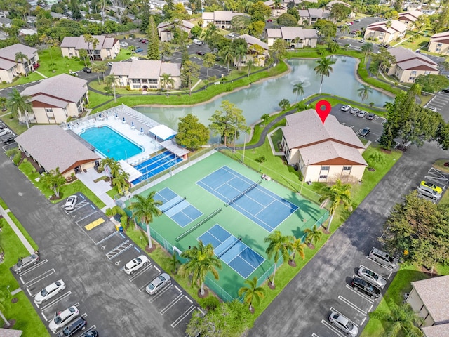 drone / aerial view featuring a water view and a residential view