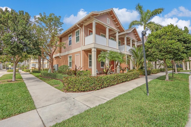 exterior space featuring a balcony and a yard