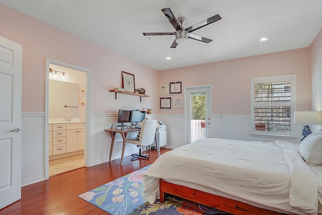 bedroom with connected bathroom, hardwood / wood-style flooring, ceiling fan, and access to exterior