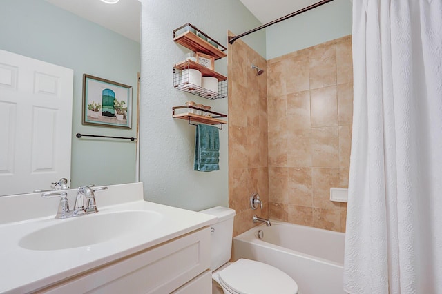 full bathroom with vanity, shower / tub combo, and toilet