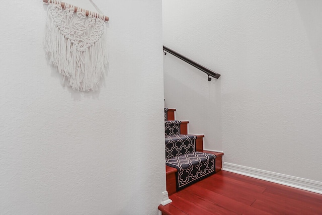 stairs featuring hardwood / wood-style floors