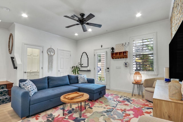 living room with ceiling fan and light hardwood / wood-style flooring