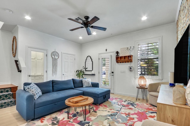 living room featuring ceiling fan and light hardwood / wood-style flooring