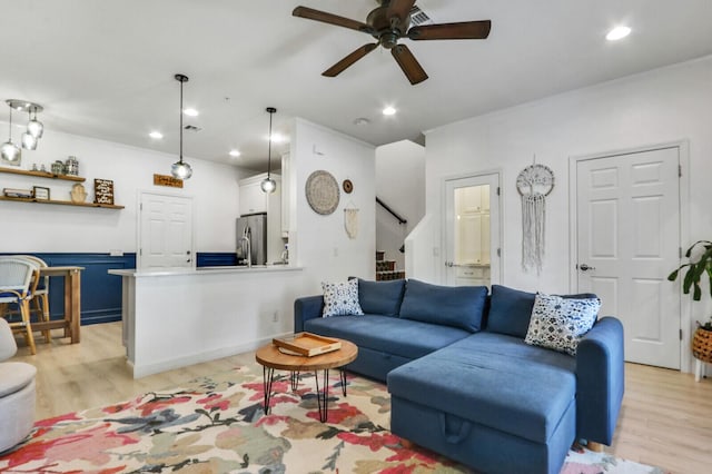 living room featuring ceiling fan and light hardwood / wood-style floors