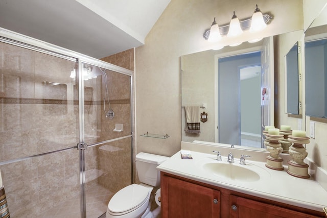 bathroom with vanity, a shower stall, and toilet