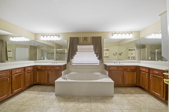 bathroom with a sink, a stall shower, tile patterned floors, and a bath