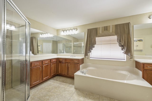 full bath with a bath, tile patterned flooring, a stall shower, and vanity