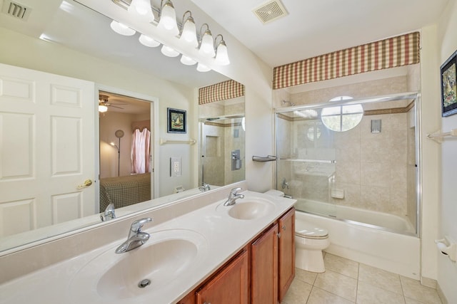 ensuite bathroom featuring tile patterned floors, visible vents, and a sink