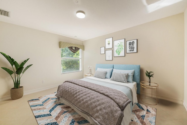 tiled bedroom with visible vents and baseboards