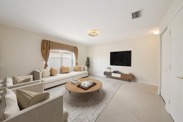 living area featuring light tile patterned floors, baseboards, and visible vents