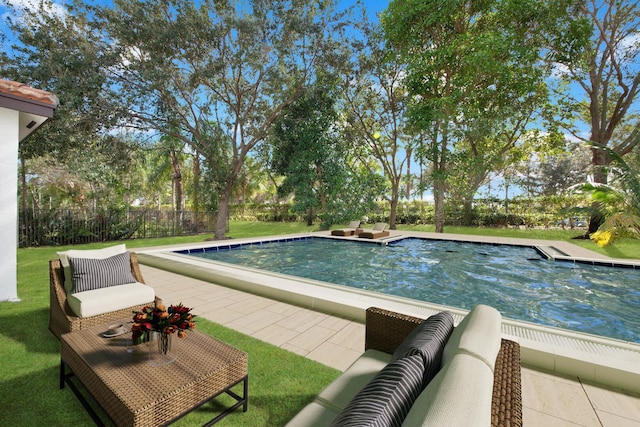 view of pool featuring a fenced in pool, fence, a lawn, and a patio area